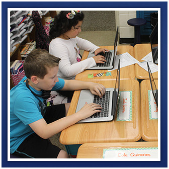 Students use laptops at their desks